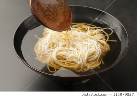 Add noodles, broth, boiled noodles, pour noodle soup with a wooden ladle 115979827