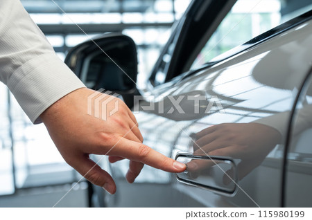 A man opens a car door with a fingerprint. Integrated handle. 115980199