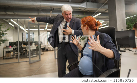 Elderly Caucasian man shouts at pregnant submissive woman and points to the door.  115980726