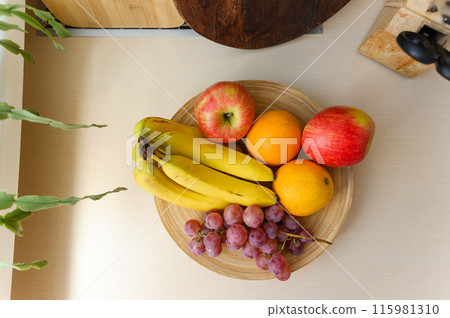 A plate of fruit on the kitchen table. A plate of fruit on the kitchen table. 115981310