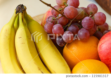 A plate of fruit on the kitchen table. 115981317