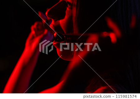 Caucasian woman puts on a gag. BDSM concept. Caucasian woman puts on a gag. BDSM concept. 115981574