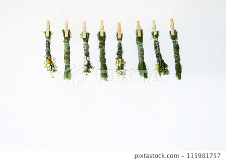 Handmade smudge sticks hanging from rope to dry. 115981757