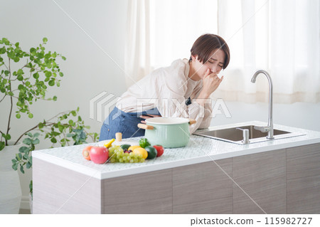 A woman who vomits while cooking due to morning sickness (kitchen, housewife) A woman who vomits while cooking due to morning sickness (kitchen, housewife) 115982727
