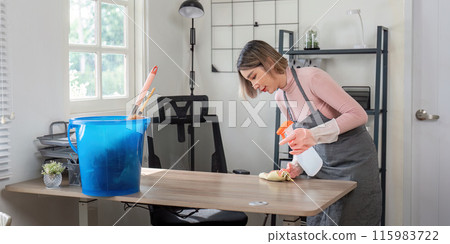 Professional Maid Cleaning Modern Home Office with Spray Bottle and Cloth for Housekeeping and Maintenance Professional Maid Cleaning Modern Home Office with Spray Bottle and Cloth for Housekeeping and Maintenance 115983722