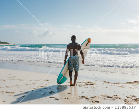 Young African American male surfer with surfboard on sandy coast near ocean 115985537