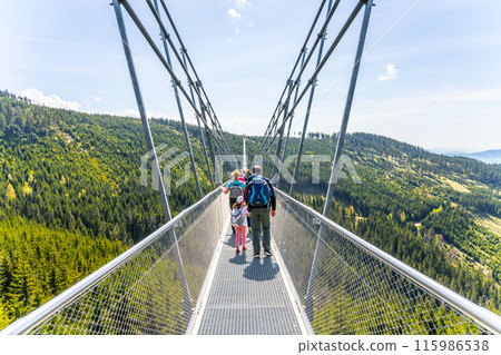 The Sky Bridge 721 is the worlds longest suspension footbridge in Dolni Morava Resort, Czechia. Visitors enjoy scenic forest views as they walk. 115986538