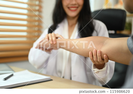 Physiotherapist examining male patient with frozen shoulder or joint stiffness in the clinic Physiotherapist examining male patient with frozen shoulder or joint stiffness in the clinic 115986620