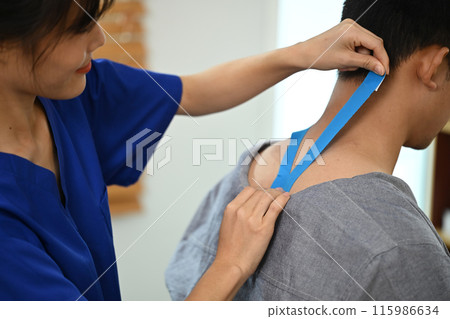 Cropped shot of female physical therapist applying kinesiotape on man patient neck. Kinesiology and rehabilitation concept 115986634