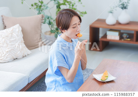 Woman eating melon dessert 115988357