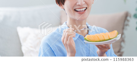 Woman eating melon dessert Woman eating melon dessert 115988363