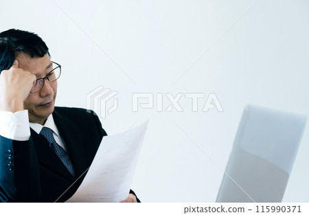 A man in charge of recruitment looking at documents A man in charge of recruitment looking at documents 115990371
