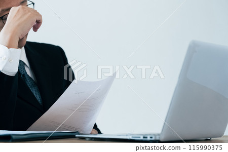 A man in charge of recruitment looking at documents 115990375