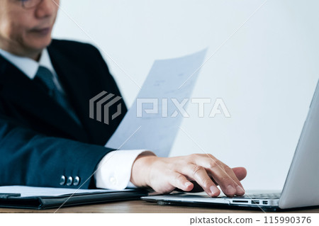 A man in charge of recruitment looking at documents 115990376