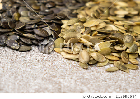 Different types of peeled pumpkin seeds, close-up Different types of peeled pumpkin seeds, close-up 115990684