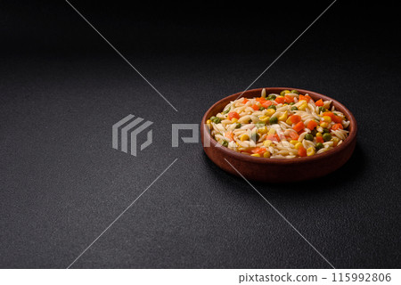 Delicious boiled rice with vegetables corn, carrots, peas with salt Delicious boiled rice with vegetables corn, carrots, peas with salt 115992806