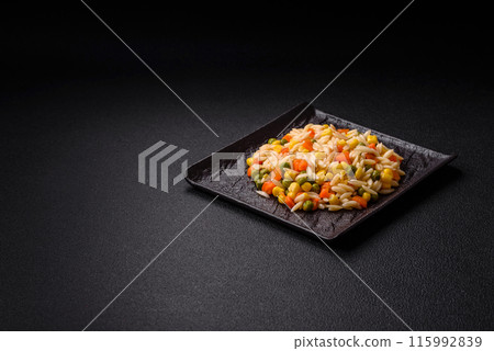 Delicious boiled rice with vegetables corn, carrots, peas with salt Delicious boiled rice with vegetables corn, carrots, peas with salt 115992839