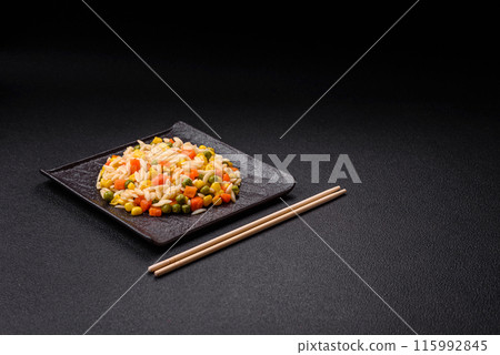 Delicious boiled rice with vegetables corn, carrots, peas with salt 115992845
