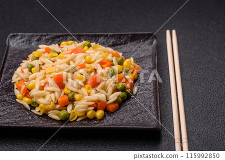 Delicious boiled rice with vegetables corn, carrots, peas with salt Delicious boiled rice with vegetables corn, carrots, peas with salt 115992850