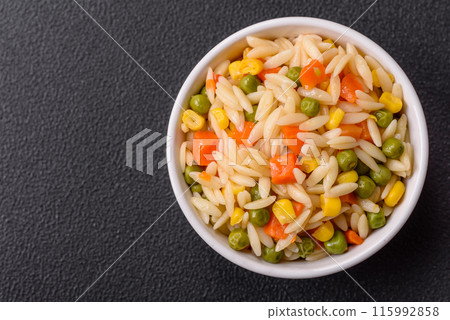 Delicious boiled rice with vegetables corn, carrots, peas with salt 115992858