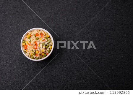 Delicious boiled rice with vegetables corn, carrots, peas with salt 115992865