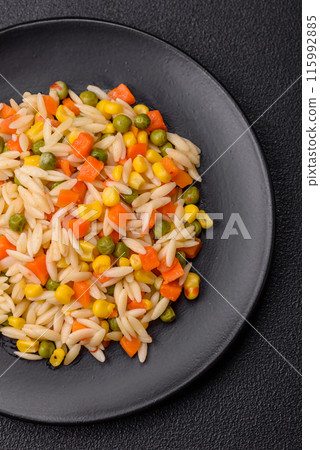 Delicious boiled rice with vegetables corn, carrots, peas with salt Delicious boiled rice with vegetables corn, carrots, peas with salt 115992885