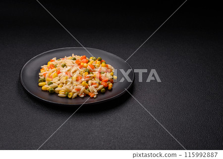 Delicious boiled rice with vegetables corn, carrots, peas with salt Delicious boiled rice with vegetables corn, carrots, peas with salt 115992887