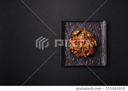 Spicy Asian dish with sliced meat fillet, hot pepper, carrots and sesame seeds Spicy Asian dish with sliced meat fillet, hot pepper, carrots and sesame seeds 115992910