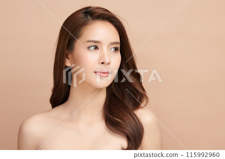 Beautiful young asian woman with clean fresh skin on beige background, Face care, Facial treatment, Cosmetology, beauty and spa, Asian women portrait. Beautiful young asian woman with clean fresh skin on beige background, Face care, Facial treatment, Cosmetology, beauty and spa, Asian women portrait. 115992960