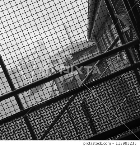 Satellite dish photographed trough a wires. 115993233