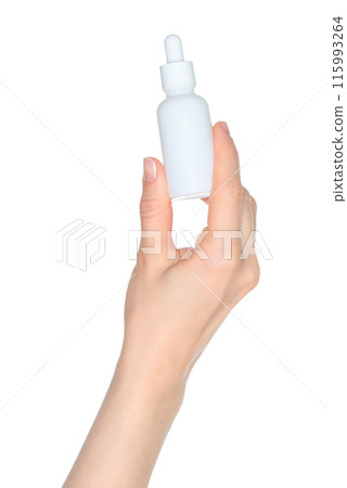 Woman hand holds a white cosmetic bottle, isolated on white background close-up, template 115993264