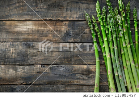 Fresh asparagus on wooden background 115993457