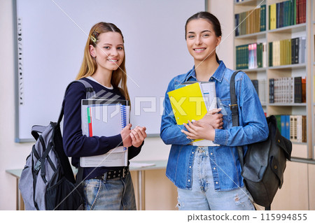 Portrait of two teenage female students together in library classroom Portrait of two teenage female students together in library classroom 115994855