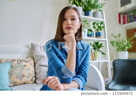 Web cam view of young attractive woman talking in home interior Web cam view of young attractive woman talking in home interior 115994872