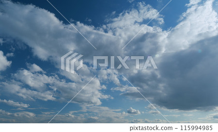 Fluffy layered clouds sky atmosphere. Majestic amazing blue sky with clouds. White and blue colors. Timelapse. 115994985