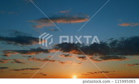 Gold orange sunset sky cloudscape. Dramatic sunset. Summer sky. Timelapse. 115995065