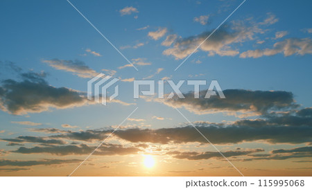 Beautiful sunset with clouds. Sun shines at the level of the horizon and warm tones colors. Timelapse. Beautiful sunset with clouds. Sun shines at the level of the horizon and warm tones colors. Timelapse. 115995068