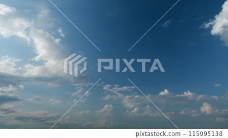 Cloud stratocumulus nature background. Blue sky with cumulus clouds and sun. Nature background of airy cloudscape. Timelapse. 115995138