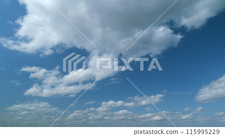 Blue sky with white stratocumulus and cumulus clouds. Sunny background, blue sky with white cumulus clouds. Timelapse. 115995229