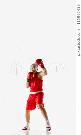 Poster. Young athletic man, focused on his work of arms and timing boxer in red uniform training against white studio background. 115995459