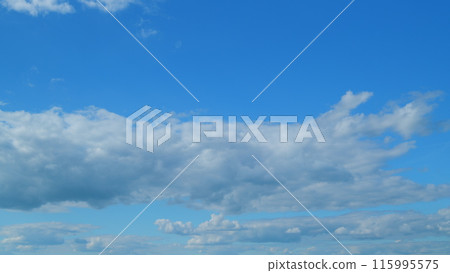 Soft white clouds. Clouds form against a dark blue sky. Blue sky white clouds. Time lapse. 115995575