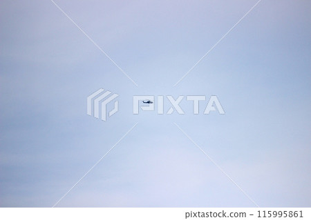 Photograph a helicopter flying in the distant sky Photograph a helicopter flying in the distant sky 115995861