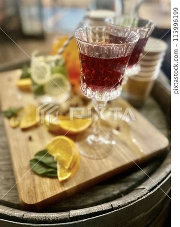 Refreshing summer cocktail with orange, lemon and mint on wooden background Refreshing summer cocktail with orange, lemon and mint on wooden background 115996199