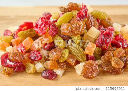Assorted dried fruits on a wooden board 115996911