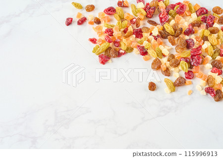 Assorted dried fruits on a wooden board Assorted dried fruits on a wooden board 115996913