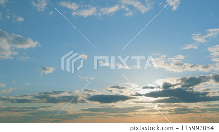 Evening sky at sunset in different shades. Beautiful romantic and colorful sky with brightly gradient color. Timelapse. 115997034