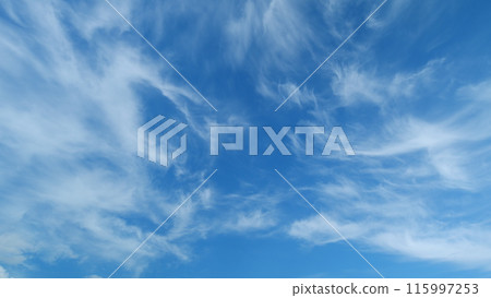 White cirrus or cirrostratus cloudscape on beautiful sunny clear sky. Tropical summer sunlight. Timelapse. 115997253