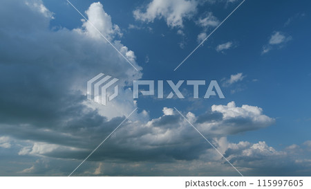 Dramatic sky with gray dark clouds before rain. Powerful cumulus clouds with a dark base. Timelapse. 115997605