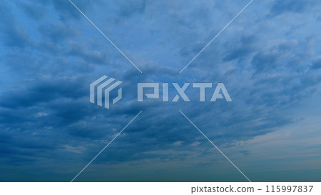 Intense dramatic panoramic sunset. Abstract different shades clouds at sunset sky background. Timelapse. Intense dramatic panoramic sunset. Abstract different shades clouds at sunset sky background. Timelapse. 115997837