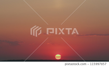 Dramatic sunset with sun rays in sky through orange clouds. Bright orange sunset sun sets behind clouds. Timelapse. Dramatic sunset with sun rays in sky through orange clouds. Bright orange sunset sun sets behind clouds. Timelapse. 115997857